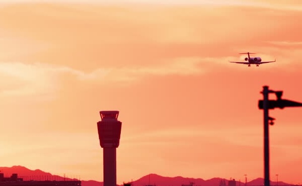 plane flying in the sunset